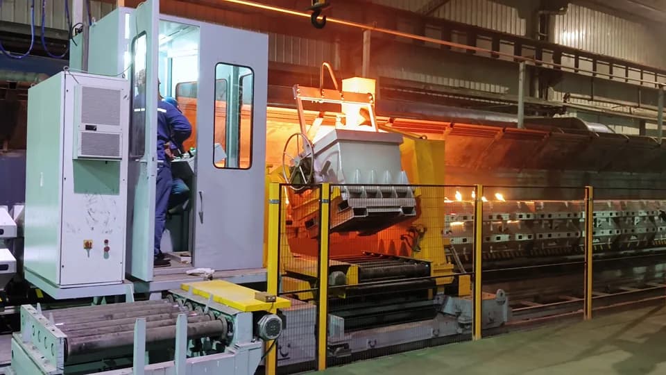 Molten metal being poured into molds on the pouring conveyor